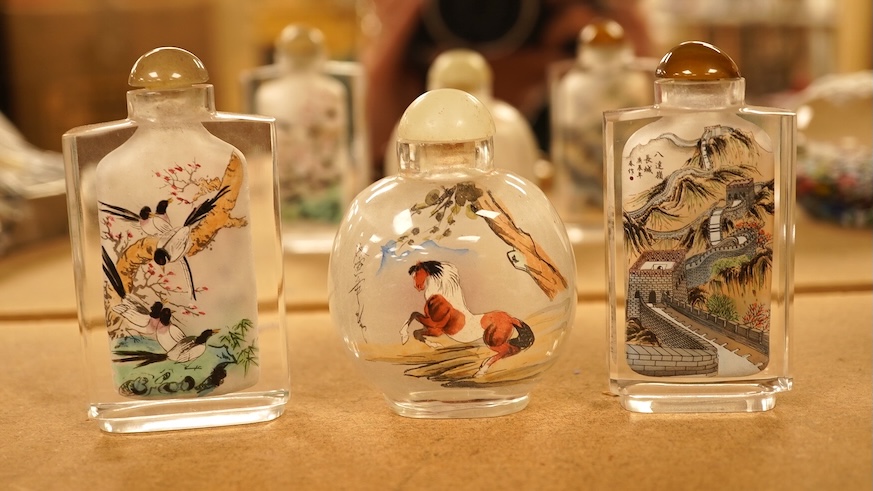 A collection of Chinese and Japanese items comprising snuff bottles, blue and white seal box and netsukes, largest 9cm high
